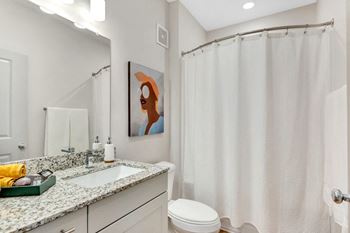 A bathroom with a shower and a sink and a toilet  at anthem luxury homes and apartment rentals in huntsville, al